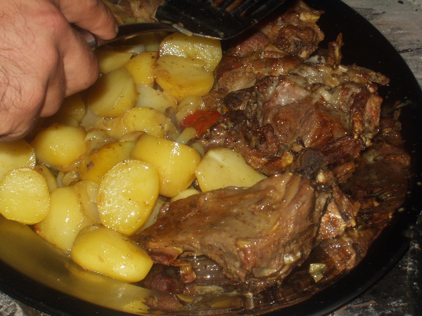 Meats and potatoes slowly roasted over the coals...DELICIOUS!